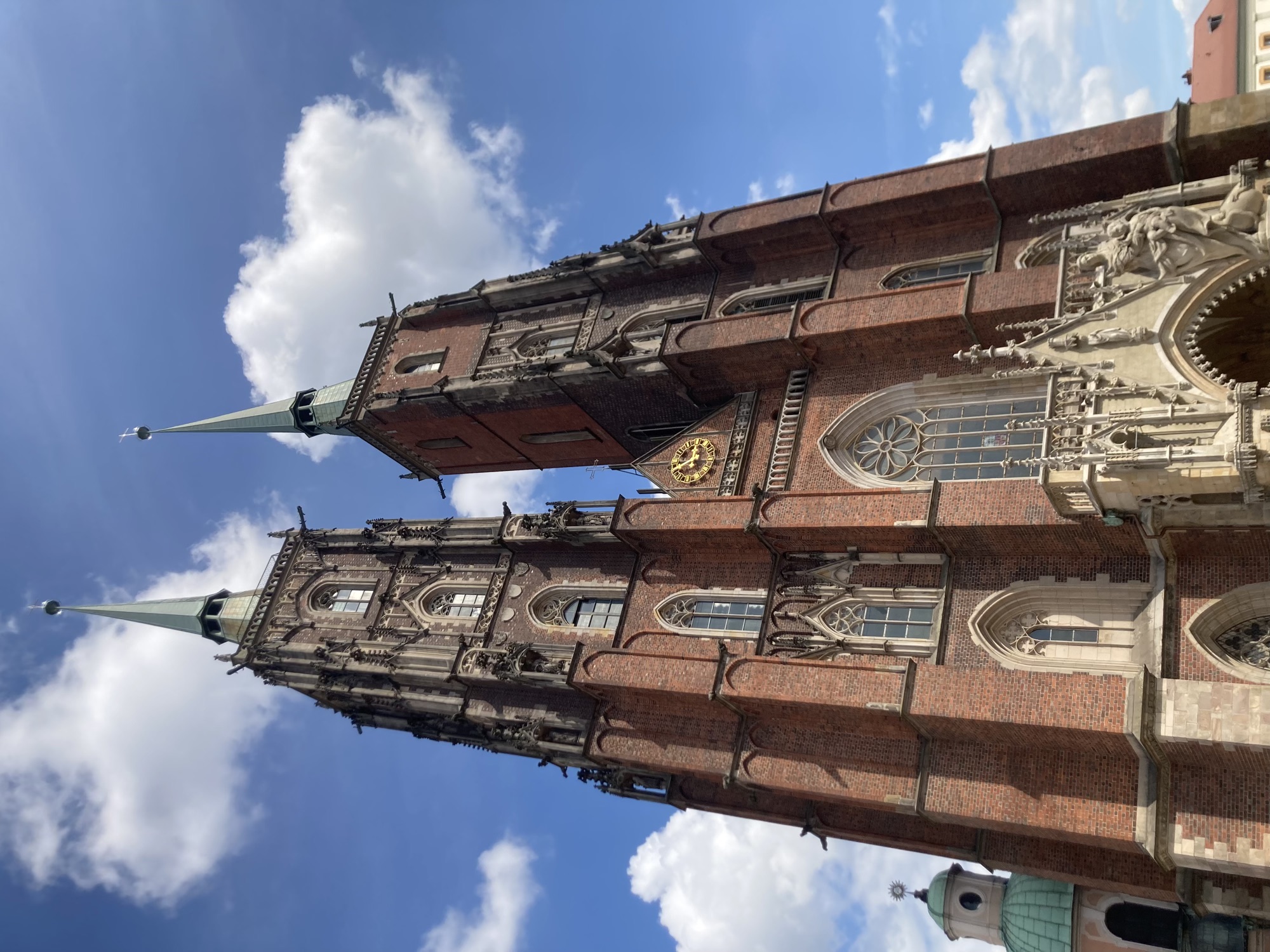imposante Backsteinkirche mit zwei hohen Türmen, die über einem dekorativen Portal gen Himmel ragen